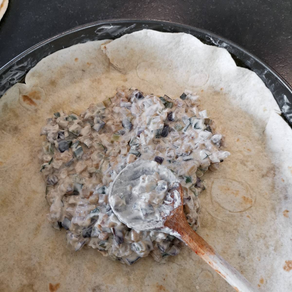 Mexikanische Tortilla Lasagne – Der perfekte Wrap Auflauf für alle Tex-Mex-Fans! Eine cremige Füllung aus Frischkäse und Gemüse wird auf die Tortillas geschichtet.